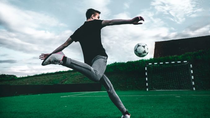 man playing soccer during daytime